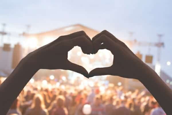 Minimalist habits - making heart with hands watching concert
