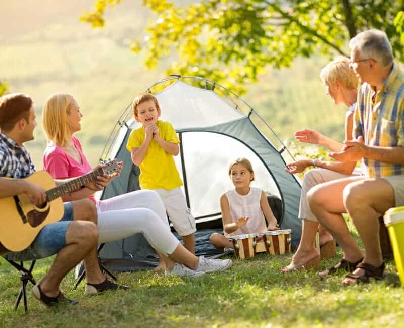 Best Experience Gifts family sitting next to camping tent
