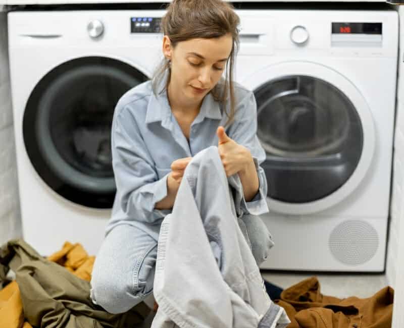 Overwhelmed by laundry: woman sorting laundry